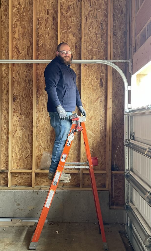 Levi installing a garage door. 